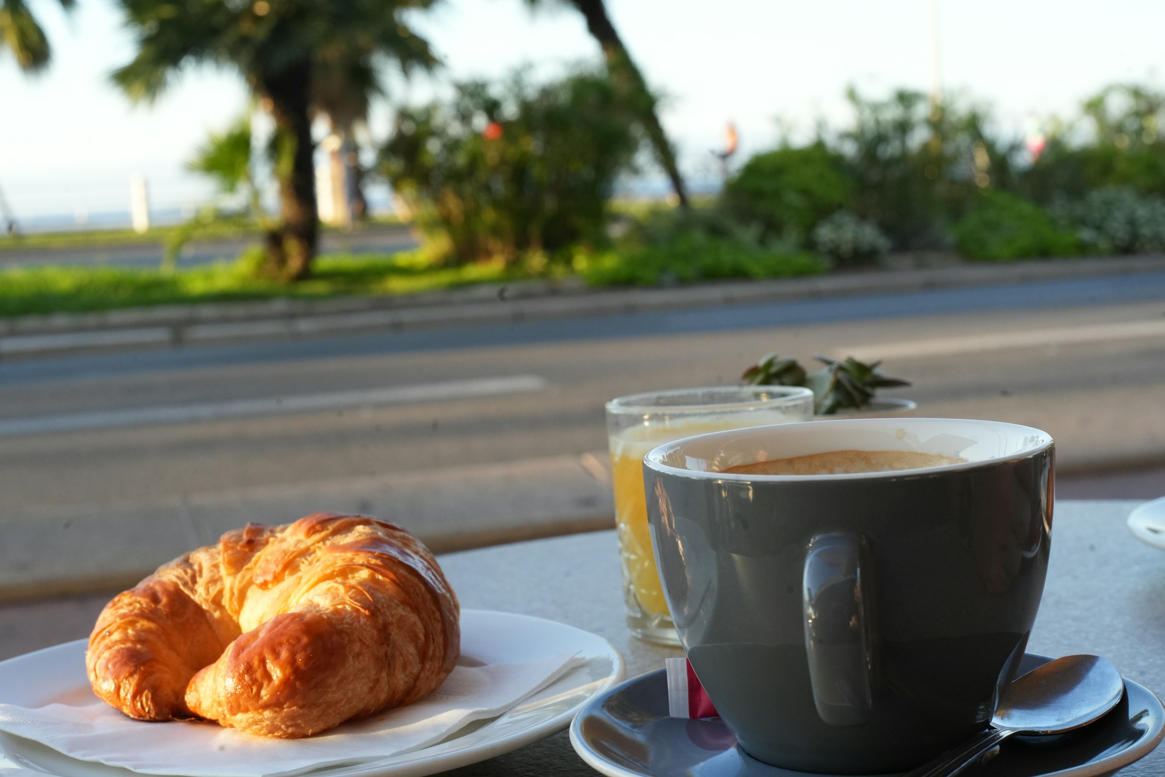 Croissant beside a coffee